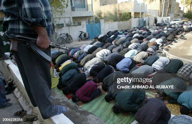 Iraqi Shiite worshipers attend the Friday noon prayers at the Huriya mosque in northwest Baghdad, 19 December the first following the capture of...