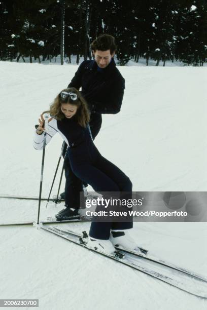 Prince Charles helping Barbara Meyer after a collision on the slopes while skiing in Klosters, Switzerland on 23rd January, 1980.