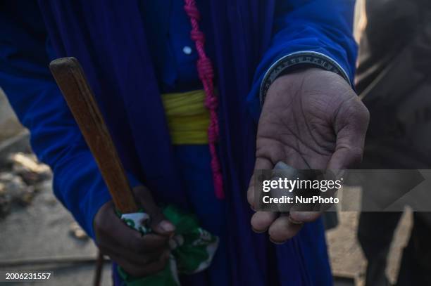 Farmer is holding rubber bullets in his hands that were fired at protesting farmers by the police as they march towards New Delhi demanding the...