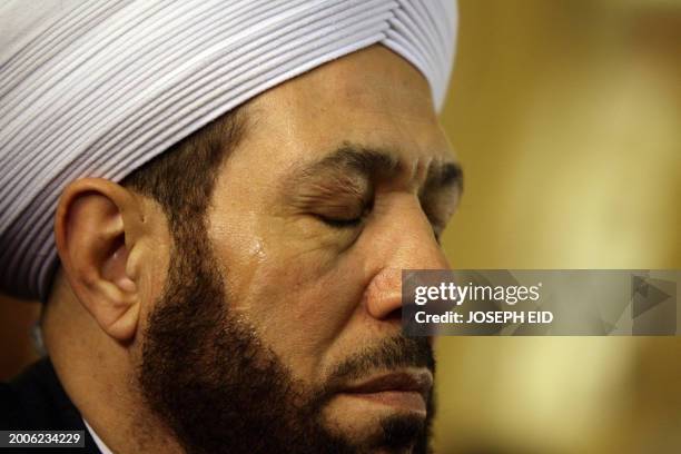 Syria's Grand Mufti Ahmad Badreddin Hassoun sheds a tear during a mass held at a Greek Orthodox church in Damascus on January 9, 2012 in memory of...