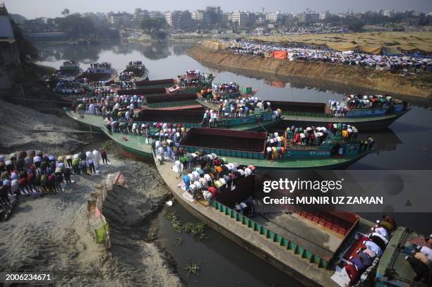 Muslim devotees bow towards Mecca as they pray during the Friday noon prayers, while they attend the World Muslim Congregation, also known as "Biswa...