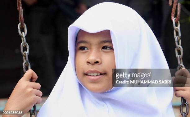 Thai Muslim student plays inside her school building guarded by the soldiers in Thailand's restive southern Yala province, 12 July 2007. Four Muslim...