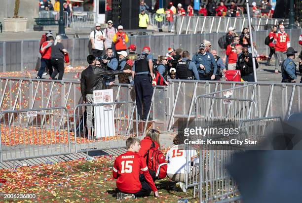 People crouch after shots rang out near Union Station after the Kansas City Chiefs Super Bowl LVIII championship rally on Wednesday, Feb. 14 at Union...