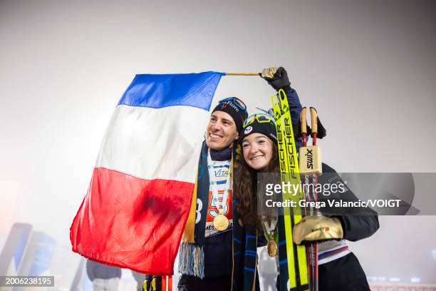Quentin Fillon Maillet of France and Lou Jeanmonnot of France looks on with the gold medal after the medal ceremony for the Single Mixed Relay at the...