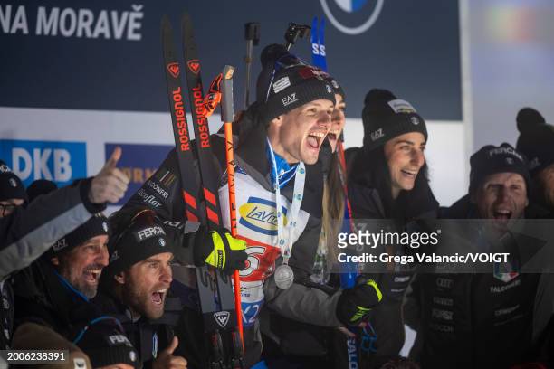 Tommaso Giacomel of Italy and Lisa Vittozzi of Italy celebrates with the team after the medal ceremony for placing second at the Single Mixed Relay...