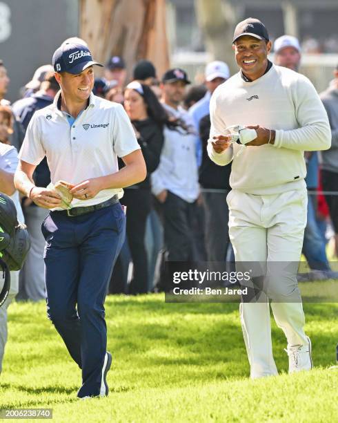 Tiger Woods smiles with Justin Thomas on the 11th hole during the first round of The Genesis Invitational at Riviera Country Club on February 15,...