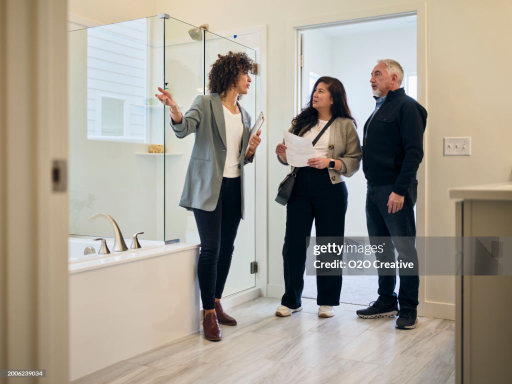Real Estate Agent Showing a New Home to Prospective Buyers