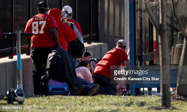People take cover after a shooting broke out following the Kansas City Chiefs Super Bowl LVIII victory parade on Wednesday, Feb. 14 in Kansas City,...