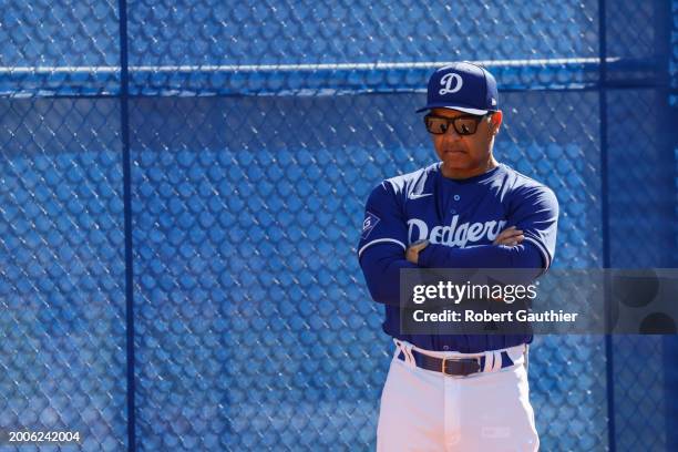 Goodyear, Arizona, Thursday, February 15, 2024 - Dodgers manager Dave Roberts looks on during a practice session for pitcher Emmet Sheehan during day...
