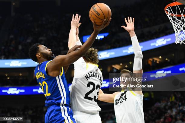 Andrew Wiggins of the Golden State Warriors shoots over Lauri Markkanen of the Utah Jazz during the first half of a game at Delta Center on February...