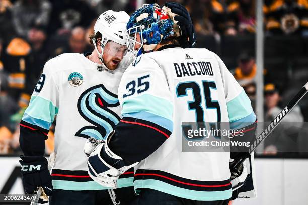 Joey Daccord of the Seattle Kraken celebrates a win with Jared McCann against the Boston Bruins at TD Garden on February 15, 2024 in Boston,...