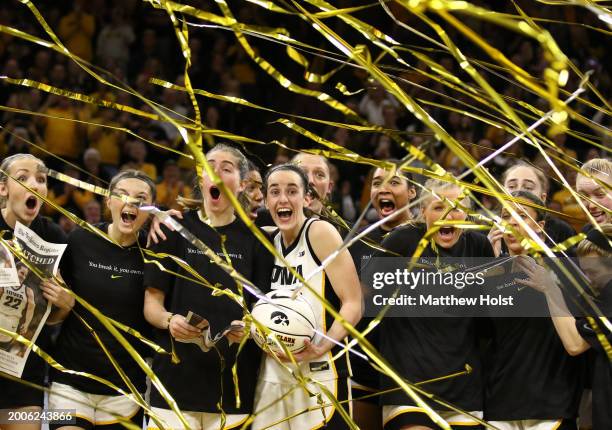 Guard Caitlin Clark of the Iowa Hawkeyes celebrates with teammates during a presentation after breaking the NCAA women's all-time scoring record...