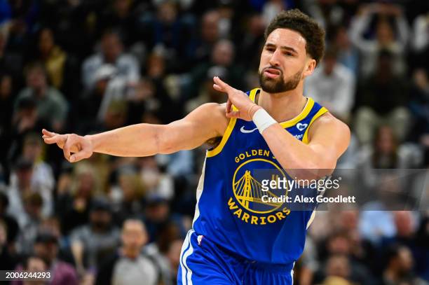 Klay Thompson of the Golden State Warriors celebrates a three point shot during the second half of a game against the Utah Jazz at Delta Center on...