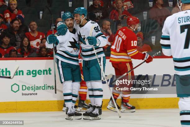 Filip Zadina, Justin Bailey of the San Jose Sharks celebrate a goal against the Calgary Flames at Scotiabank Saddledome on February 15, 2024 in...