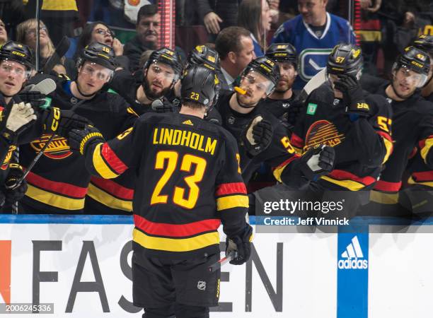 Elias Lindholm of the Vancouver Canucks celebrates his goal with teammates during the third period of their NHL game against the Detroit Red Wings at...