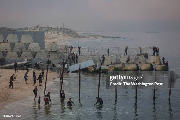 Palestinians on the beach near the border separating the Gaza Strip and Egypt in the Rafah refugee camp, southern Gaza Strip, February 13, 2024.