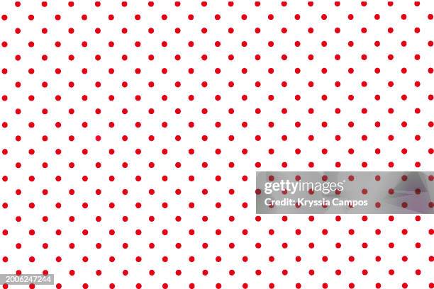 flat texture of red polka dots on a white colored background - red polka dot stock pictures, royalty-free photos & images