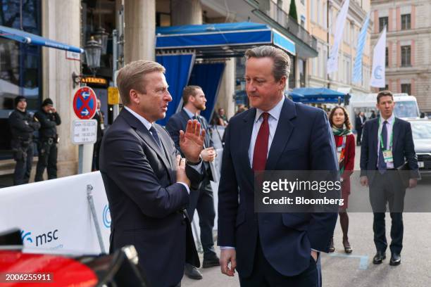 Oliver Zipse, chief executive officer of BMW AG, left, speaks with David Cameron, UK foreign secretary, on the opening day of the Munich Security...