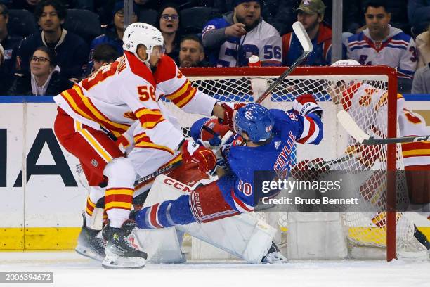 Oliver Kylington of the Calgary Flames is called for interference during the first period against Will Cuylle of the New York Rangers at Madison...