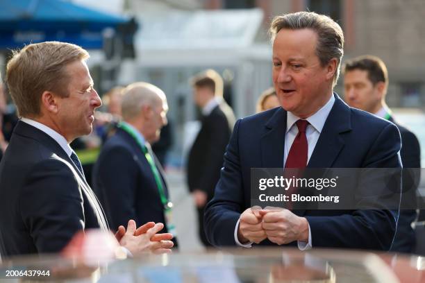 Oliver Zipse, chief executive officer of BMW AG, left, speaks with David Cameron, UK foreign secretary, on the opening day of the Munich Security...