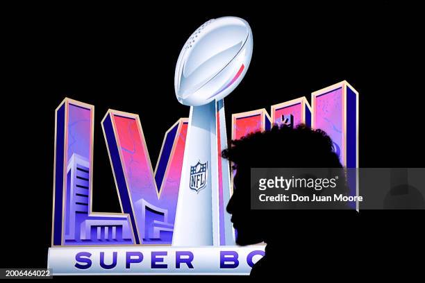 The silhouette of Quarterback Patrick Mahomes of the Kansas City Chiefs in front the Super Bowl logo during the Super Bowl Winning Team Head Coach...