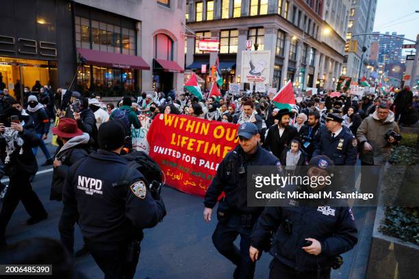 Follows along as people march calling on Israel to stop its Rafah invasion in Gaza on February 12, 2024 in New York City. Israel launched airstrikes...