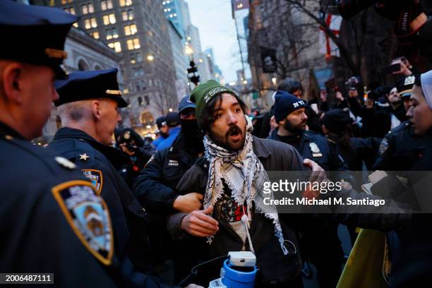 Person is arrested by NYPD as people march calling on Israel to stop its Rafah invasion in Gaza on February 12, 2024 in New York City. Israel...