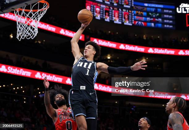 Jalen Johnson of the Atlanta Hawks dunks against Coby White of the Chicago Bulls during the first quarter at State Farm Arena on February 12, 2024 in...