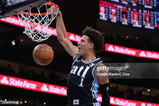 Jalen Johnson of the Atlanta Hawks dunks against Coby White of the Chicago Bulls during the first quarter at State Farm Arena on February 12, 2024 in...