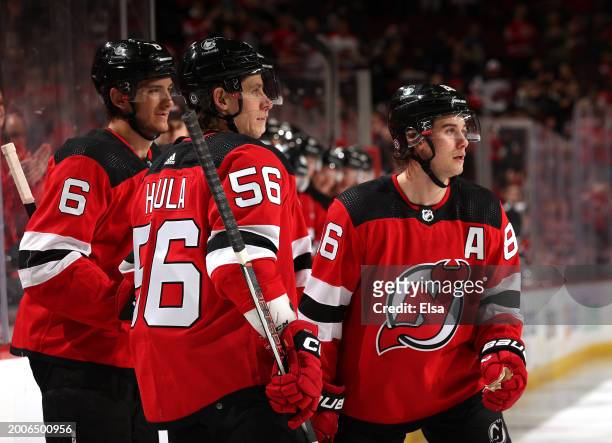 Jack Hughes of the New Jersey Devils is congratulated by teammates Erik Haula and John Marino after Hughes scored during the second against the...