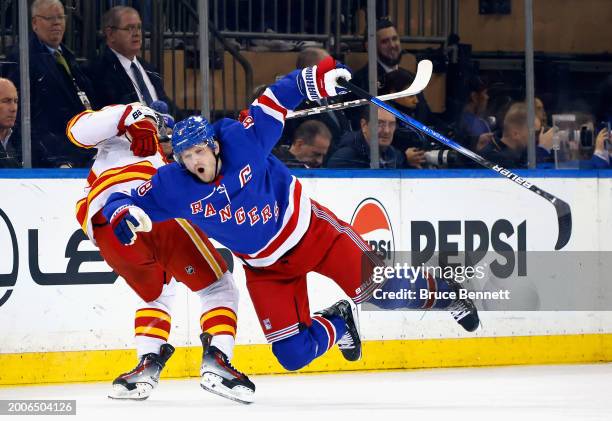 Jonathan Huberdeau of the Calgary Flames takes a second period penalty for tripping Jacob Trouba of the New York Rangers at Madison Square Garden on...