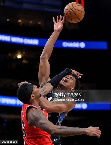 Torrey Craig of the Chicago Bulls blocks a shot by De'Andre Hunter of the Atlanta Hawks during the second quarter at State Farm Arena on February 12,...