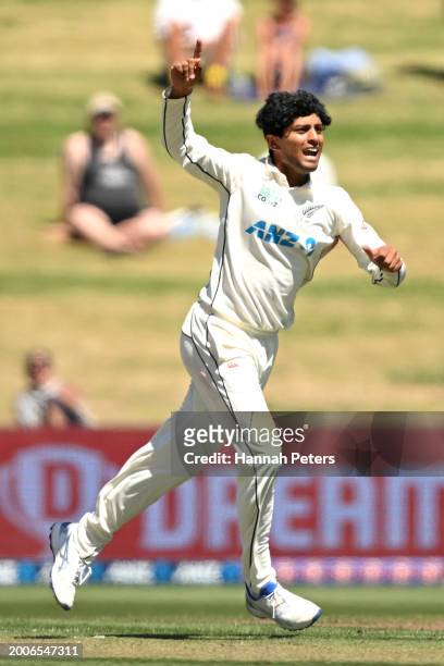 Rachin Ravindra of the New Zealand Black Caps celebrates the wicket of Keegan Petersen of South Africa during day one of the Men's Second Test in the...