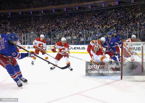 Jacob Markstrom of the Calgary Flames makes a first period save on Blake Wheeler of the New York Rangers at Madison Square Garden on February 12,...