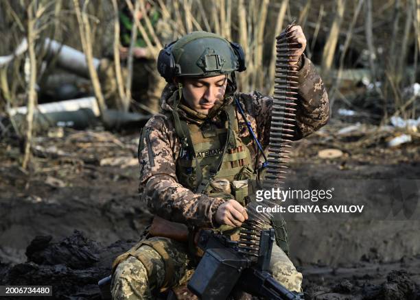 Ukrainian serviceman of the Air Assault Forces loads his machinegun on a frontline in an undisclosed location, Southern Ukraine on February 14 amid...