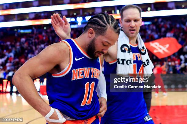 Jalen Brunson of the New York Knicks and Charlie Brown Jr. #44 walk off the court after losing to the Houston Rockets 105-103 at Toyota Center on...