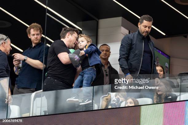 Elon Musk helps his son to his seat prior to the NFL Super Bowl 58 football game between the San Francisco 49ers and the Kansas City Chiefs at...