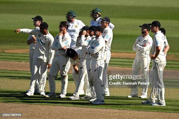The Black Caps wait for a review during day one of the Men's Second Test in the series between New Zealand and South Africa at Seddon Park on...