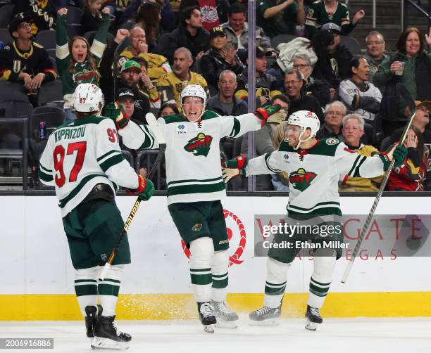 Kirill Kaprizov, Matt Boldy and Dakota Mermis of the Minnesota Wild celebrate Boldy's third-period goal against the Vegas Golden Knights at T-Mobile...