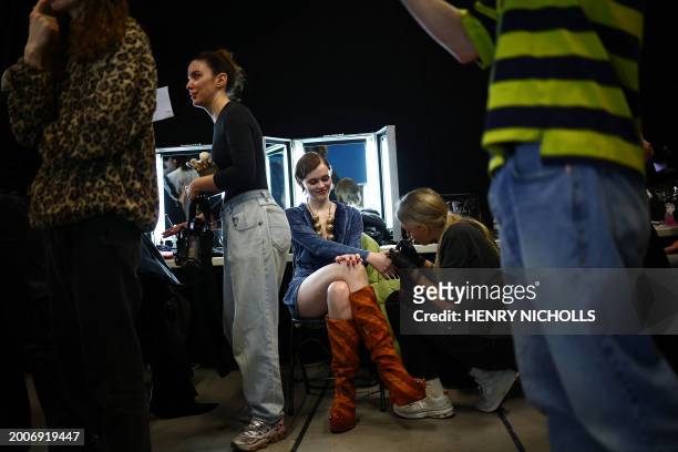 Model gets nails done backstage ahead of a catwalk presentation for London-based Ukrainian designer Masha Popova's Autumn/Winter 2024 collection,...