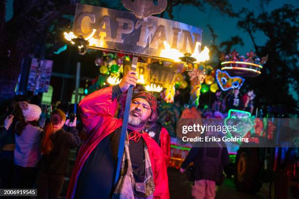 Flambeaux light the way for the Krewe of Orpheus parade during 2024 Mardi Gras on February 12, 2024 in New Orleans, Louisiana.