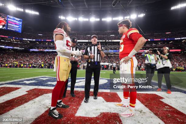 Fred Warner of the San Francisco 49ers and Patrick Mahomes of the Kansas City Chiefs look onto the coin toss before overtime of Super Bowl LVIII at...