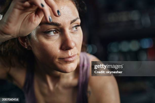 exhausted athletic woman cleaning sweat in a gym. - suor imagens e fotografias de stock