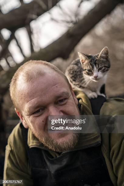 Cats play with Ukrainian soldiers waiting for the order to fire a D20 Artillery gun against Russian positions as Russia-Ukraine war continues in...