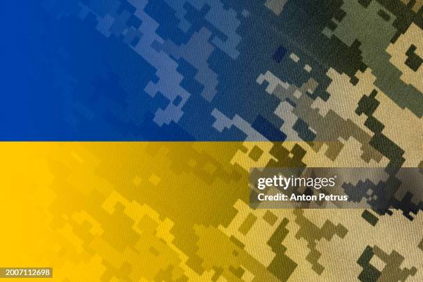 camouflage of the ukrainian army  and ukrainian flag. conscription in ukraine - ukraine government stock pictures, royalty-free photos & images