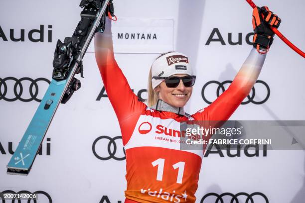 Winner Switzerland's Lara Gut-Behrami celebrates during the podium ceremony of Women's downhill event at the FIS Alpine Ski World Cup in...