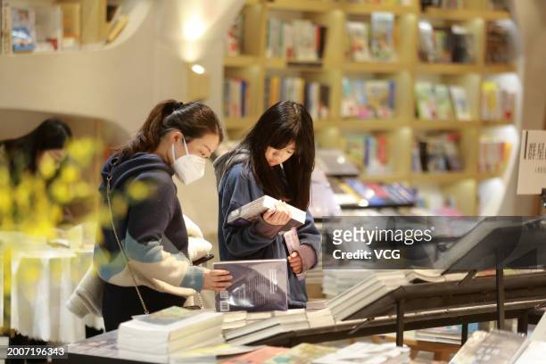 Citizens read books at a Zhongshuge bookstore to spend the Chinese Spring Festival holiday on February 13, 2024 in Yangzhou, Jiangsu Province of...