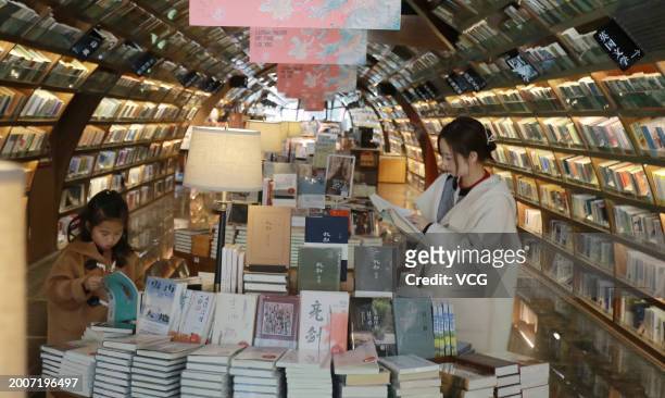 Citizens read books at a Zhongshuge bookstore to spend the Chinese Spring Festival holiday on February 13, 2024 in Yangzhou, Jiangsu Province of...