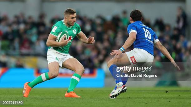 Jordan Larmour of Ireland takes on Paolo Garbisi during the Guinness Six Nations 2024 match between Ireland and Italy at Aviva Stadium on February...