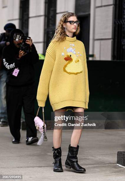 Model Apolline Rocco Fohrer is seen wearing a yellow Coach sweater, Coach boots and bag with sunglasses outside the Coach show during NYFW F/W 2024...